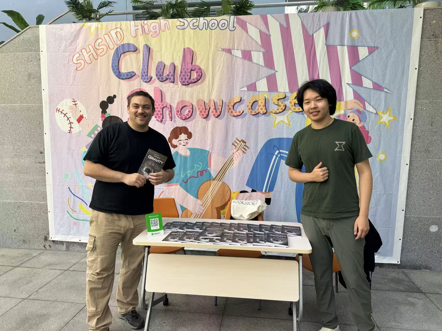 Guoshwan at right, sharing ISTORIA writing journals at SHSID’s club showcase